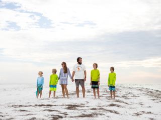 A Family Walking On The Beach